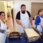 Volunteers man the gravy and mashed potatoes Thursday morning at the Lemoore Senior Citizens Center.